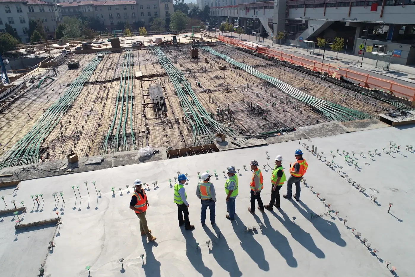 A construction team walking a post-tensioned slab deck